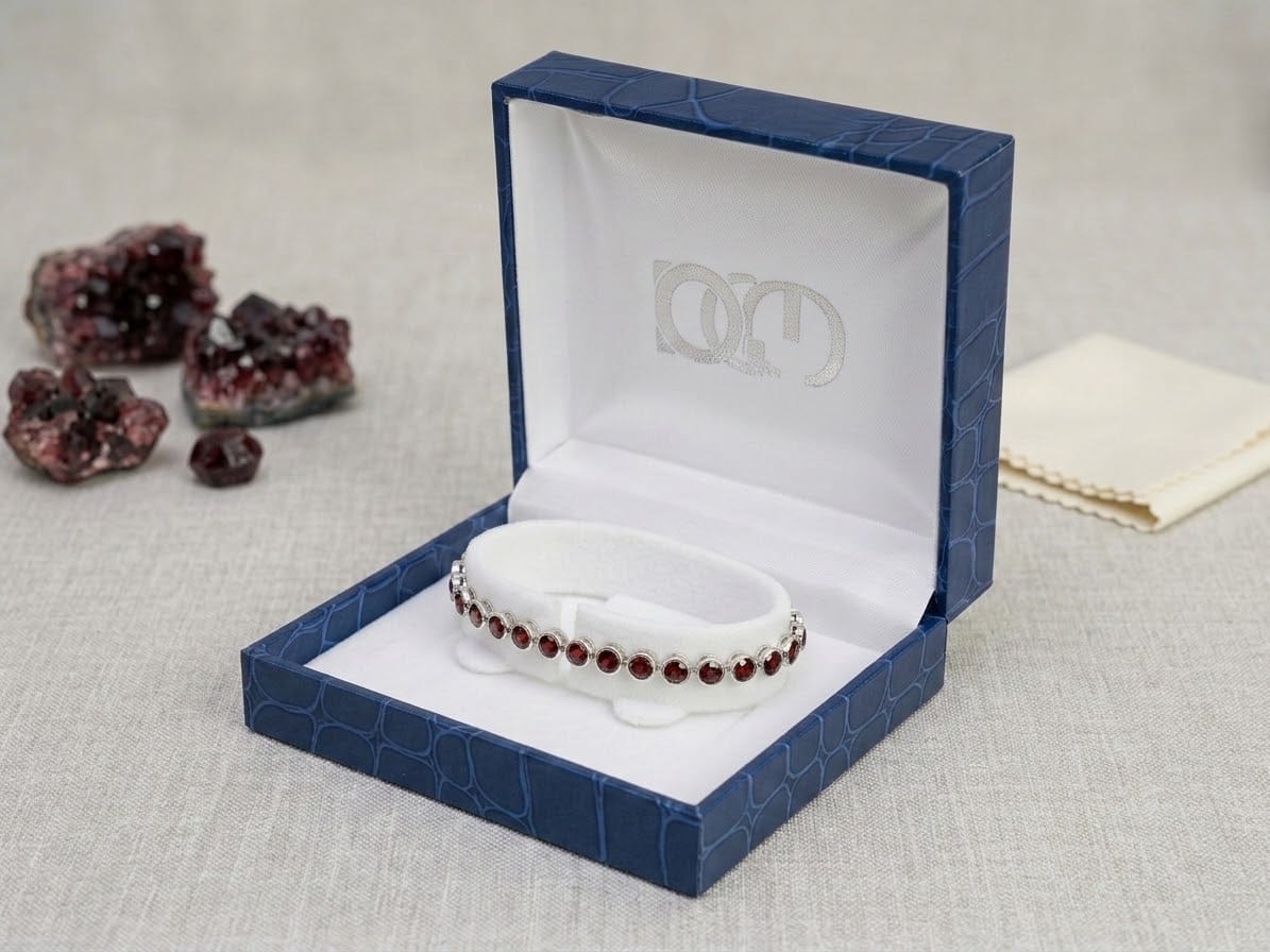 Natural Garnet Tennis Bracelet | Platinum-Plated Silver 1 Make a sophisticated statement with this beautiful natural garnet tennis bracelet. Designed with a continuous row of natural garnet gemstones, this bracelet showcases the deep red tones that make garnet such a distinctive and sought-after gemstone. The stones are set in silver with a platinum-plated finish, giving the bracelet a refined and polished appearance. The classic tennis bracelet design makes this garnet bracelet versatile enough to wear every day while also adding elegance to evening and special-occasion looks. Whether you are searching for a natural garnet bracelet, a red gemstone tennis bracelet or a unique gemstone gift, this piece is a beautiful addition to any jewellery collection. Discover natural gemstone jewellery at Gecko Jewellers, including garnet jewellery, gemstone bracelets and unique jewellery in South Africa. Product Details Natural garnet gemstones Tennis bracelet design Silver setting Platinum-plated finish Rich red gemstone colour Suitable for everyday wear and special occasions Ideal as a gemstone gift Please note: Natural gemstones can vary slightly in colour, clarity and appearance. Each stone has its own natural characteristics, making every piece unique. Pieces may vary slightly from the pictures and videos shared.